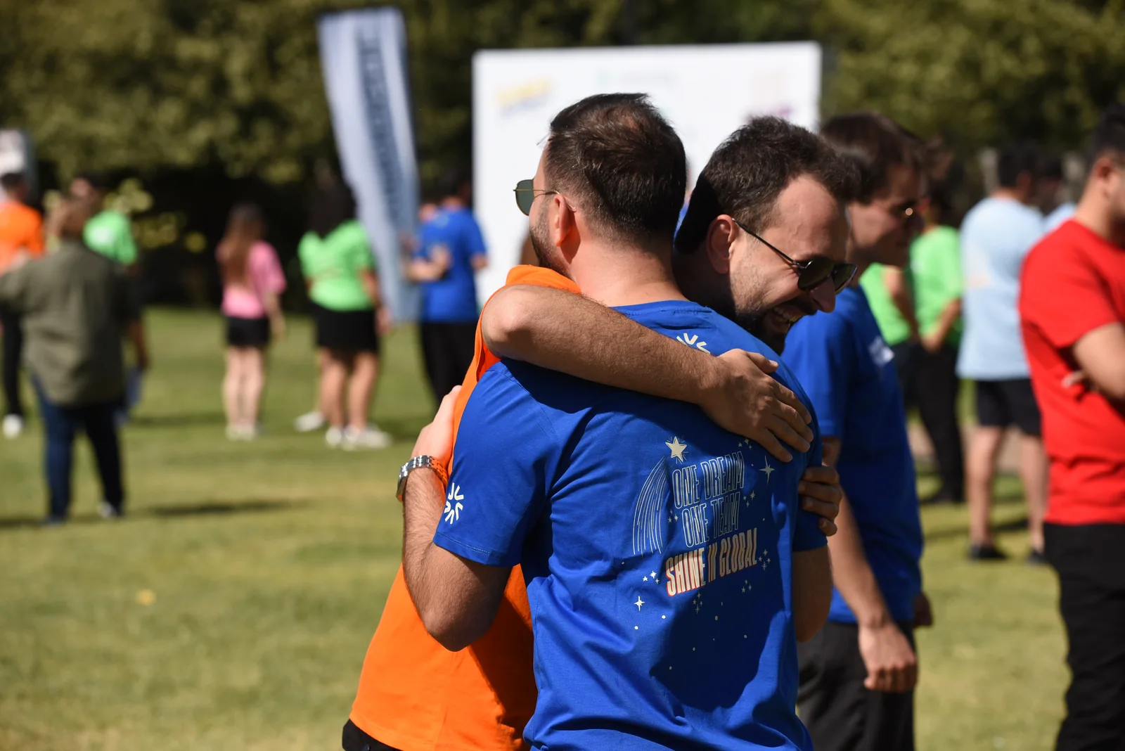 Virgosol team members embracing at an outdoor event